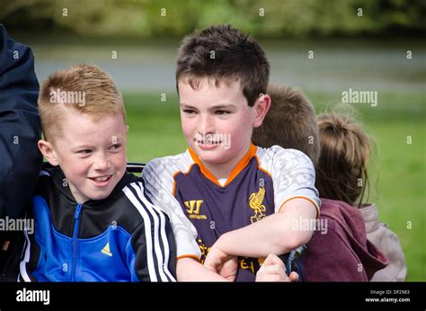 Two freckled and smiling Irish boys taking a ride in pony cart with ...