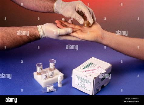 1990s HANDS PERFORMING A GUNSHOT RESIDUE TESTING PROCEDURE Stock Photo - Alamy