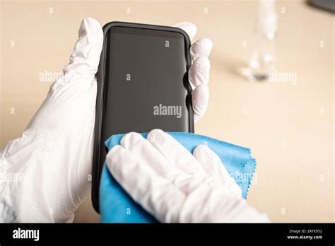 Hand cleaning smartphone screen with alcohol Stock Photo - Alamy