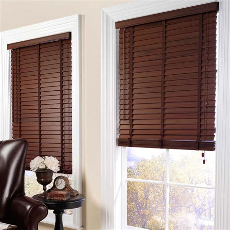 These dark wood blinds have great contrast against the clean white wall ...