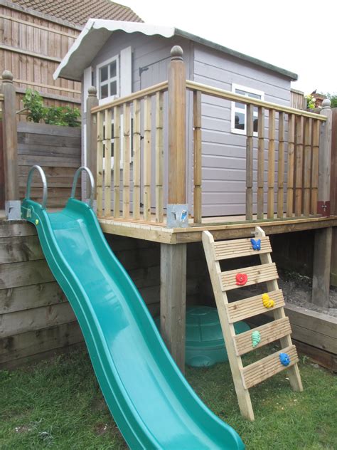 Raised wooden playhouse with ladder, slide and sandpit underneath. We have finally completed ...