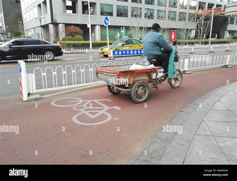 --FILE--A cyclist rides on a bicycle lane in a street in Beijing, China ...