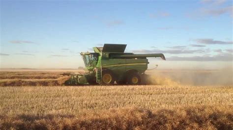 S690 harvesting in a heavy canola crop. - YouTube