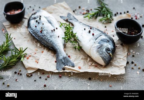 Fresh fish dorado. Dorado and ingredients for cooking on a table Stock Photo - Alamy