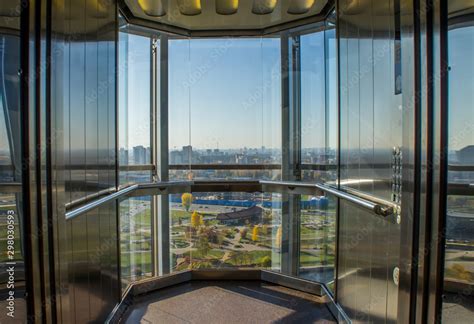 Transparent glass elevator with city view. Stock Photo | Adobe Stock