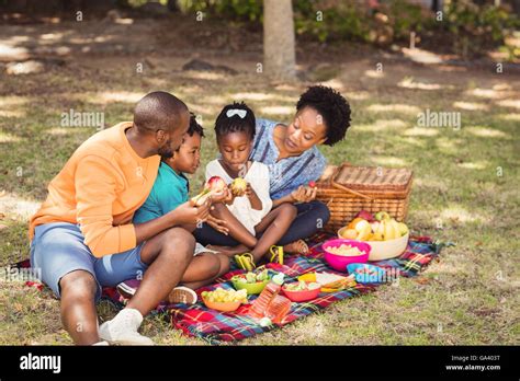 Happy family eating together Stock Photo - Alamy