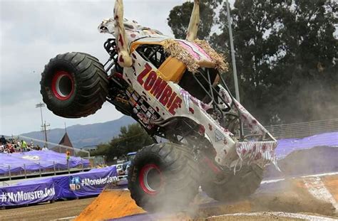 a monster truck is jumping over some dirt