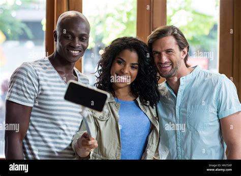 Group of friends taking a selfie from selfie stick in cafÃƒÂ© Stock Photo - Alamy