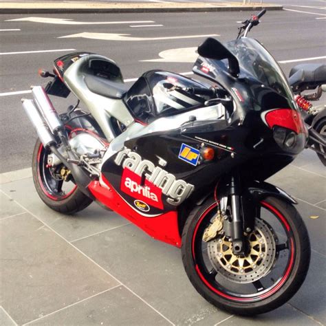 two motorcycles parked next to each other on the street