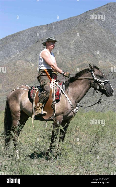 Russian President Vladimir Putin riding the horse at the spurs of the Western Sayan Mountains in ...