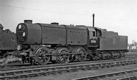 an old black and white photo of a train on the tracks