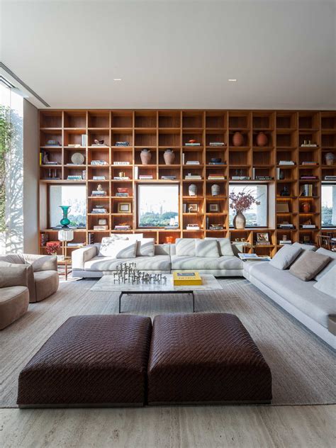 A Full-Wall Bookshelf With LED Lighting Frames The Windows Like Artwork In This Apartment ...