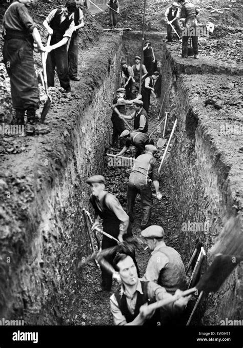 Men digging deep trenches in Birkenhead Park, which will become shelters. Birkenhead, Merseyside ...