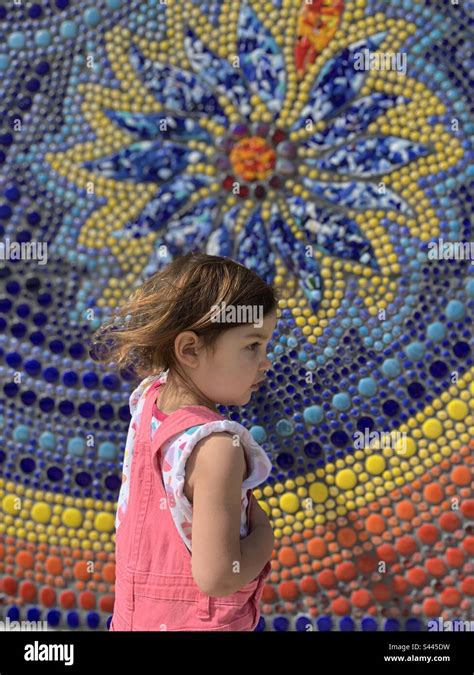 Young toddler girl standing in front of tile mosaic Stock Photo - Alamy