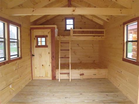 the inside of a small wooden cabin with windows