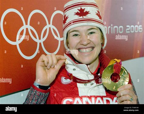 Clara Hughes of Canada shows off her gold medal won in the women's ...