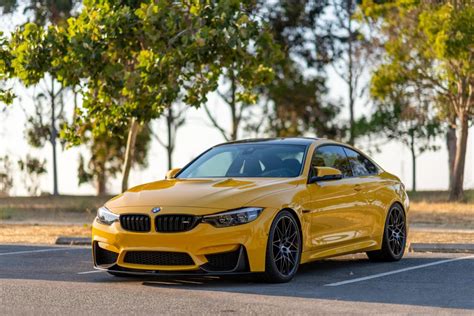 BMW M4 Competition in Speed Yellow, socially distant at the park : BMW