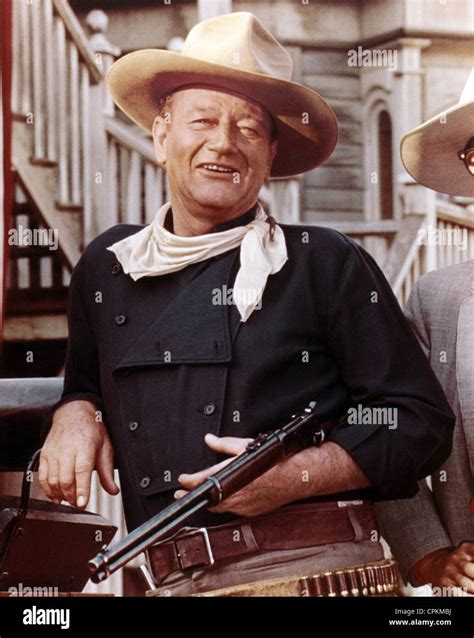 A portrait of John Wayne with shotgun in cowboy western film Stock ...