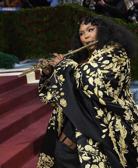 Lizzo Plays Gold John Lunn Flute on Met Red Carpet