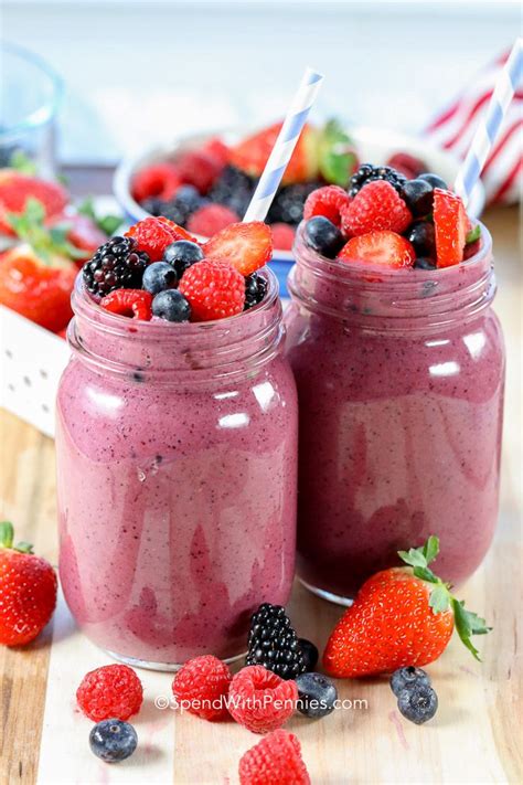 2 mixed berry smoothies topped with fresh berries ready to drink ...