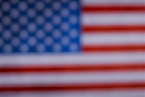 A burning sparkler over the American flag. Celebrating US Independence day, Memorial day or Flag ...
