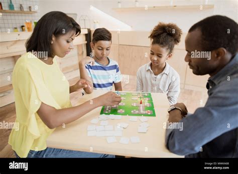 african-american family playing board game in cafe Stock Photo - Alamy