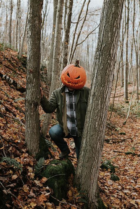 Man Wearing Scary Carved Pumpkin Head In The Woods For Halloween. #1 Photograph by Cavan Images ...