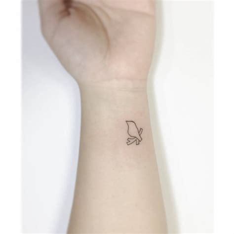 Fine line bird tattoo located on the wrist,