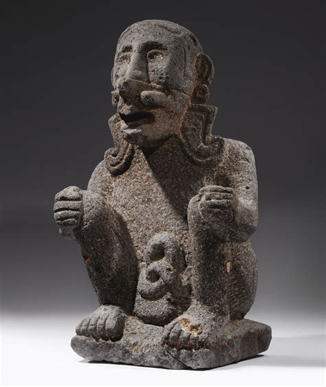 AZTEC STONE SEATED Figure with the Mask of EHECATL, ca. A.D. 1450-1521 wearing the buccal mask ...