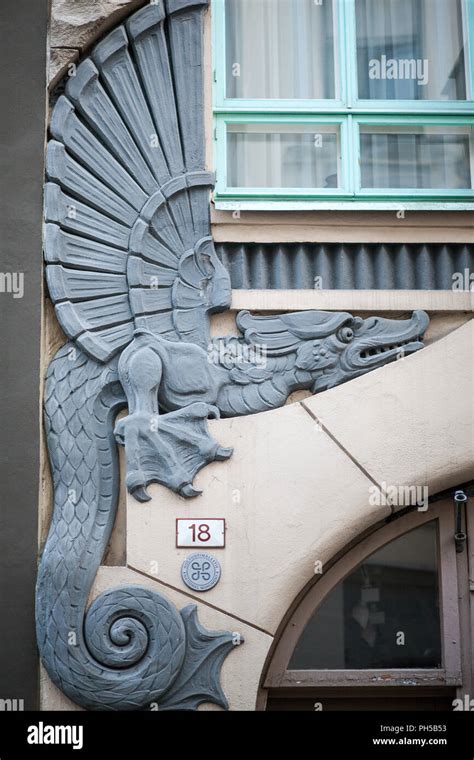 The Sculpture of the Dragon on the facade of the house Stock Photo - Alamy