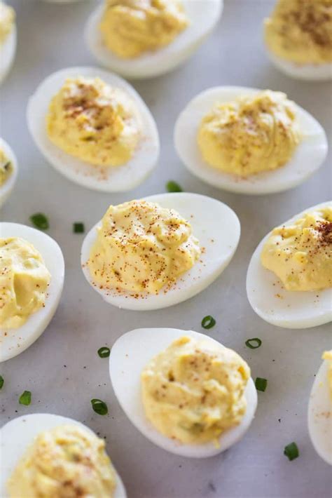 an assortment of deviled eggs on a baking sheet