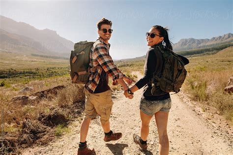 "Beautiful Young Couple On Hiking Trail In Nature Reserve" by Stocksy Contributor "Jacob Lund ...