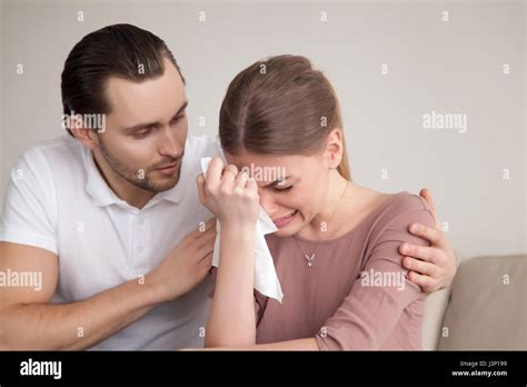 Husband comforting sad crying wife, man consoling sobbing young Stock Photo - Alamy
