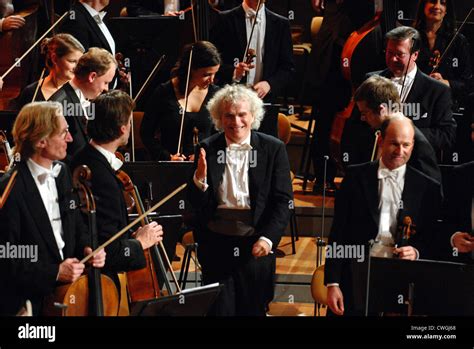 Sir Simon Rattle conducts the Berlin Philharmonic Stock Photo - Alamy