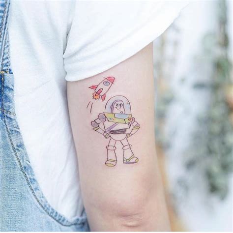 Buzz Lightyear tattoo on the tricep.