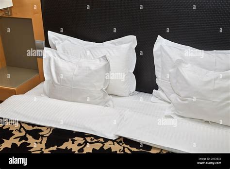 Hotel bed with white sheets Stock Photo - Alamy