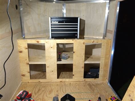 the inside of a trailer with tools and construction materials on the floor next to it