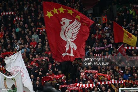 Liverpool fans waves their flags ahead of kick off in the English ...