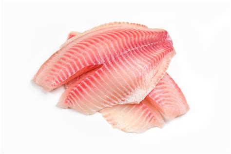 Raw tilapia fillet fish isolated on white background for cooking food - Fresh fish fillet sliced ...