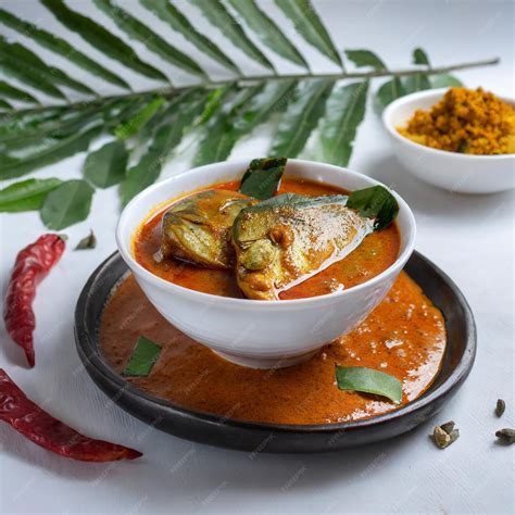 Premium Photo | Spicy fish curry_seer fish curry traditional indian fish curry white background