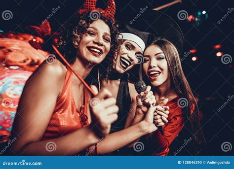 Young Women in Halloween Costumes Singing Karaoke Stock Photo - Image of club, friendship: 128846290