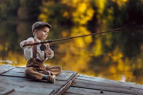 Little Boy Fishing at Sunset Stock Photo - Image of horizontal, lake ...