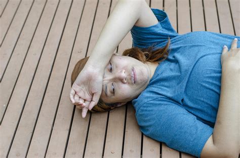 Asian woman fainting putting her hands on her forehead because of hot weather 22995193 Stock ...