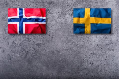 Premium Photo | Flags of the norway and sweden on concrete background.