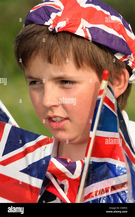 Close up portrait of a young boy adorned with Union Jack flags and other British paraphernalia ...