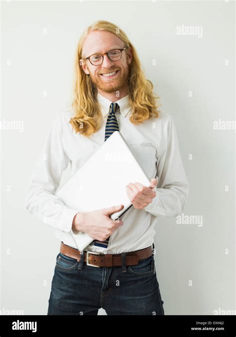 Portrait of smiling man with laptop Stock Photo - Alamy