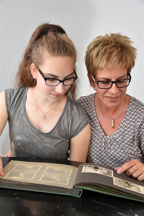 Mother and Daughter Looking at Photo Album Stock Image - Image of ...