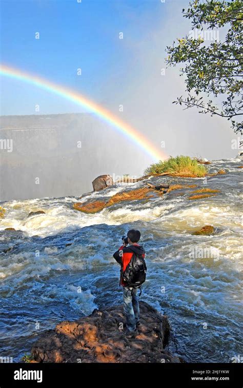 tourist photographing the Victoria falls, Zambia Stock Photo - Alamy