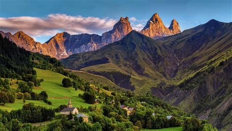 church in a village in the french alps with mountains 3000 meters high. Green meadows in spring ...