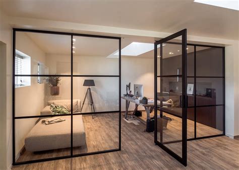 Crittall style fixed glass partitions with a pivot door in the middle | Glass wall office ...